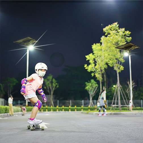 Girl skateboarding under lights at night
