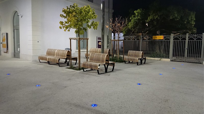 Nowatt Crystal Studs with blue LEDs illuminating a public plaza at night, enhancing benches, trees, and pathways with safe, sustainable design