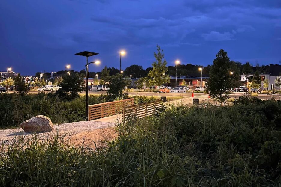 "Solar parking lot lights providing energy-efficient illumination in a large commercial lot.