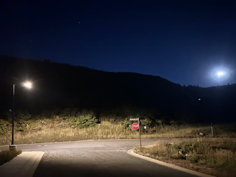 Off-grid solar street lighting improving safety and visibility in a rural municipal roadway at night.