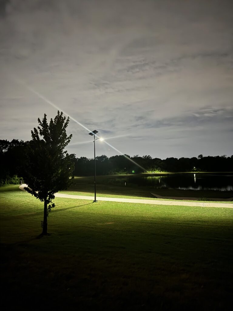 Fonroche SmartLight providing bright, uniform lighting along a park pathway at night, with no grid connection.