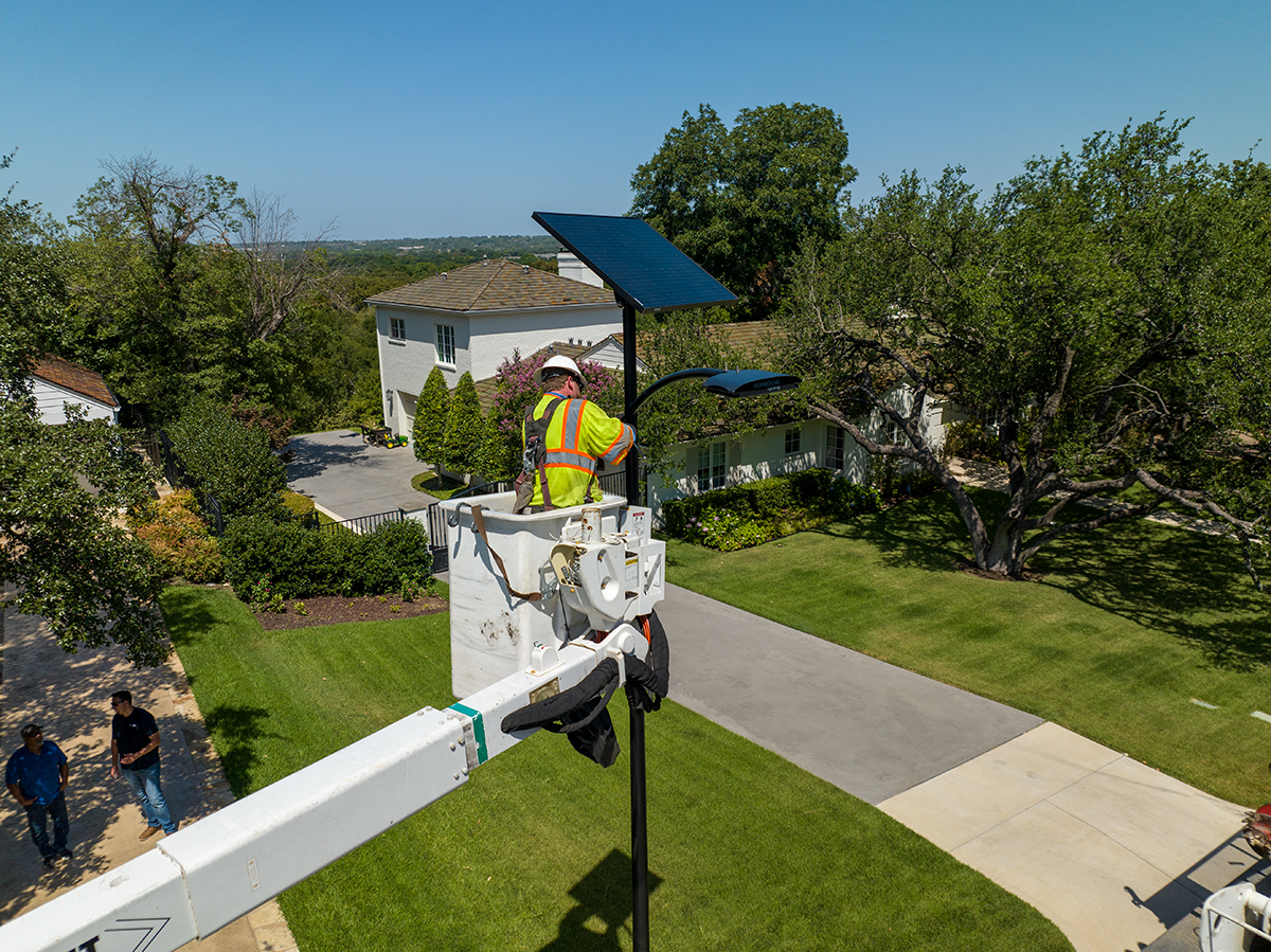 Fonroche Lighting Solar Streetlight Installation Technician installing Fonroche solar street lighting in a residential neighborhood