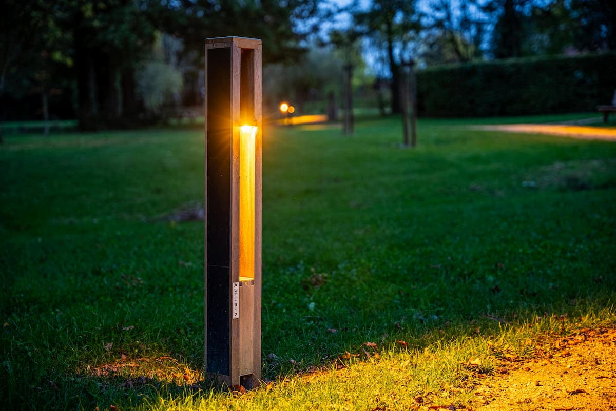 solar-pathway-and-landscape-lighting-bollards Architectural solar bollard lighting installed in a landscaped outdoor environment