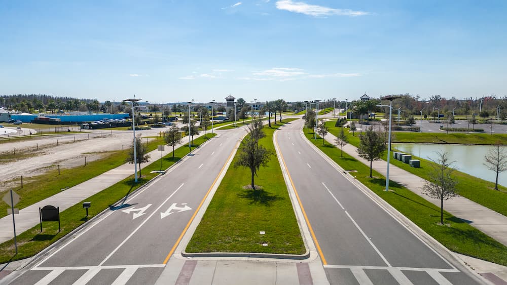 Aerial view of a divided road with solar street lights in south Carolina under clear blue skies 