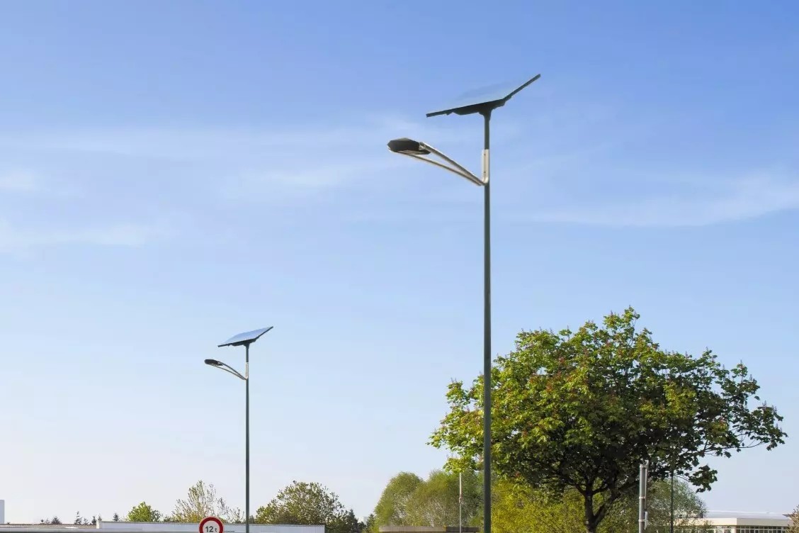 new-art-solar-street-light Fonroche NEW ART solar street lights installed along a roadway, featuring geometric diamond-inspired LED luminaires designed for modern urban streets and public spaces.