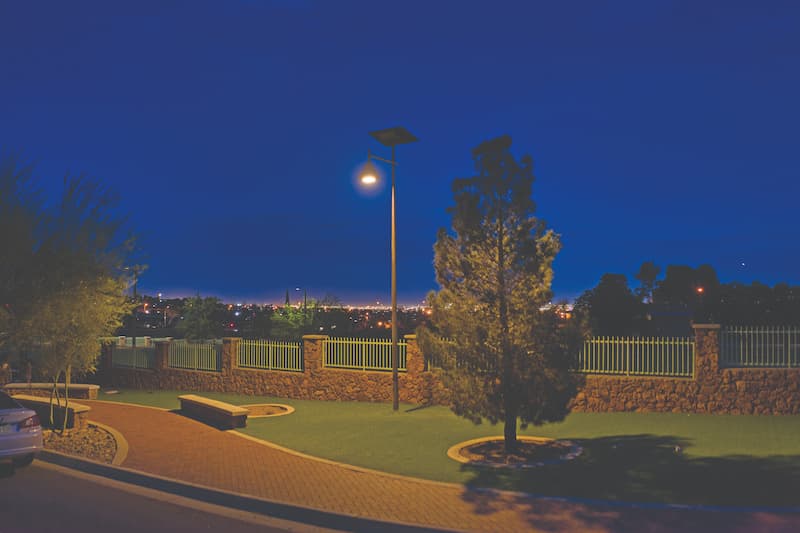 Fonroche SmartLight solar streetlight illuminating a landscaped urban park at night—off-grid, energy-independent lighting that enhances safety and visibility with zero utility infrastructure.