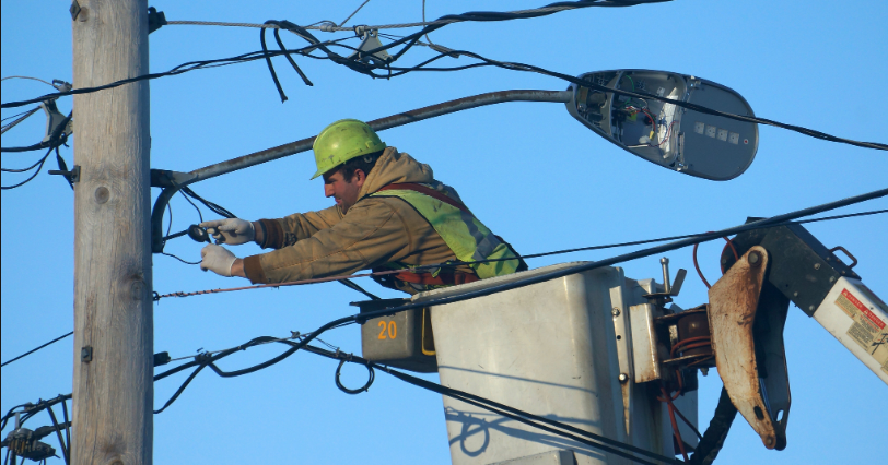 old street light getting repaired by a municipal worker
