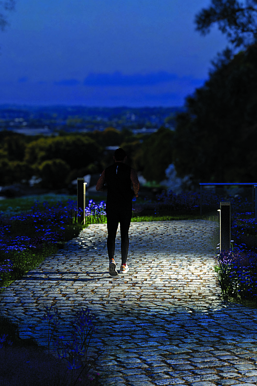 BRUT solar bollard light with a minimalist fiber concrete design displayed on geometric concrete blocks, showcasing durable architectural lighting for urban spaces and pathways.