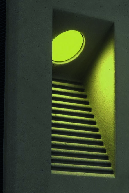 Close-up view of an architectural solar bollard light showcasing its illuminated optics and modern design.