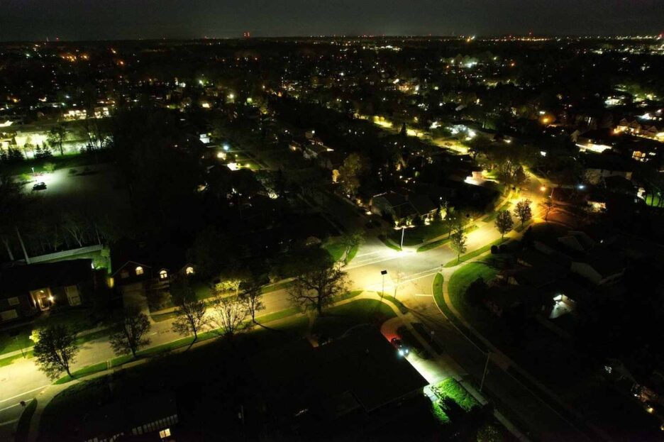 Aerial view of Florida neighborhood illuminated by streetlights at night, highlighting the cost challenges of grid lighting versus solar lighting.