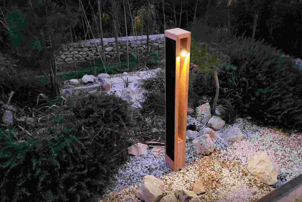 NOWATT solar bollard illuminating a landscaped garden pathway, combining modern design with sustainable, off-grid lighting for improving accessibility