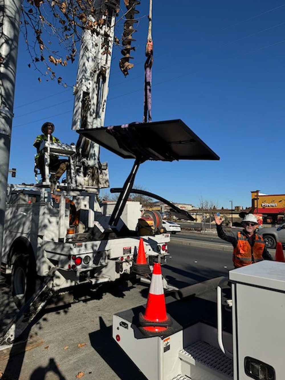 Augusta city crews installing a Fonroche SmartLight solar streetlight for the Windsor Spring Road project, assembling the system before deployment along the corridor.