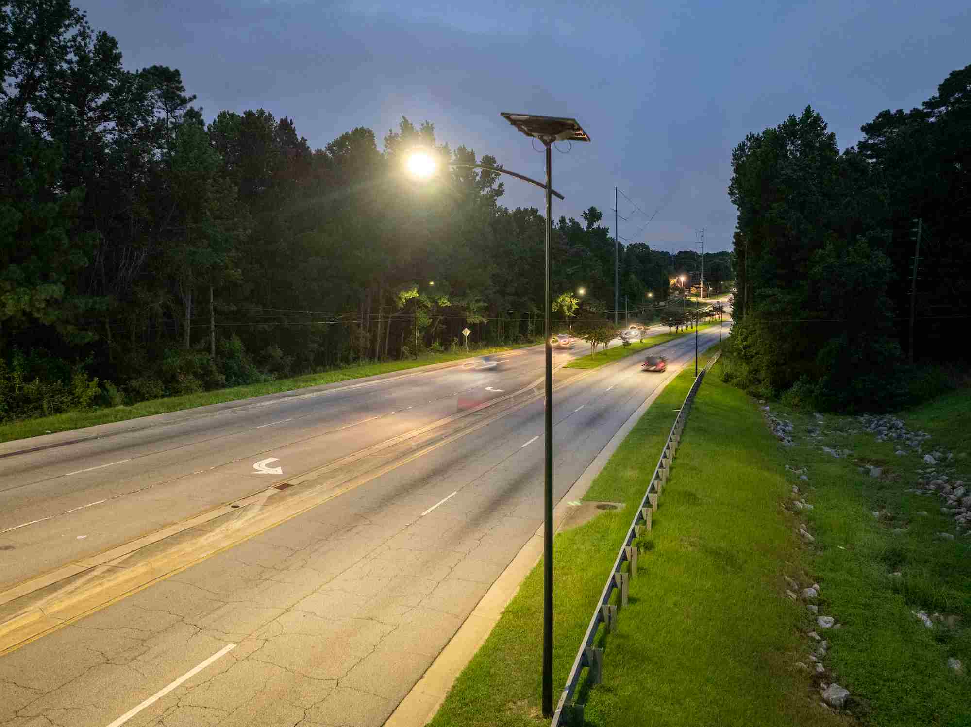 Solar-powered streetlights illuminating Augusta’s Windsor Spring Road at night, improving visibility for vehicles and pedestrians.