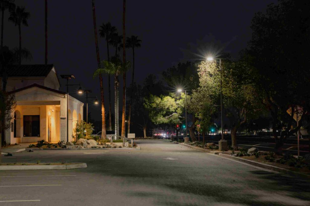 Solar-powered streetlights illuminating a California parking lot at night with sustainable LED lighting