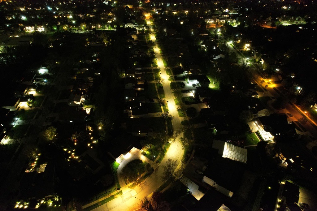Nighttime view of a residential neighborhood in Alabama with streetlights illuminating homes and roadways in a community setting.
