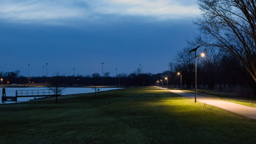 Solar-powered streetlights illuminating a park pathway and waterfront in Alabama, providing safe, reliable off-grid lighting for public spaces.