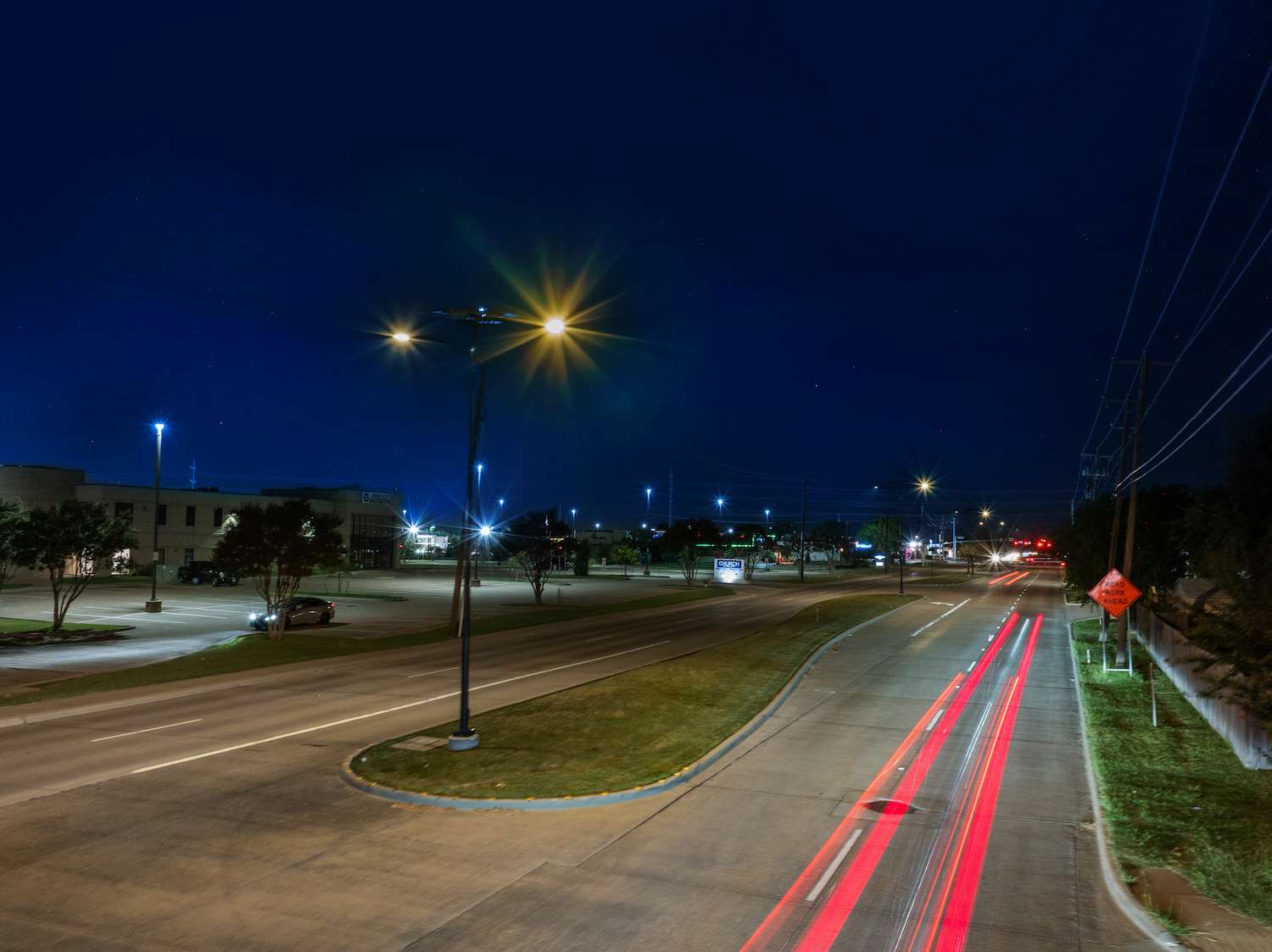 Nighttime view of solar-powered streetlights illuminating Route 66 in Rowlett, Texas
