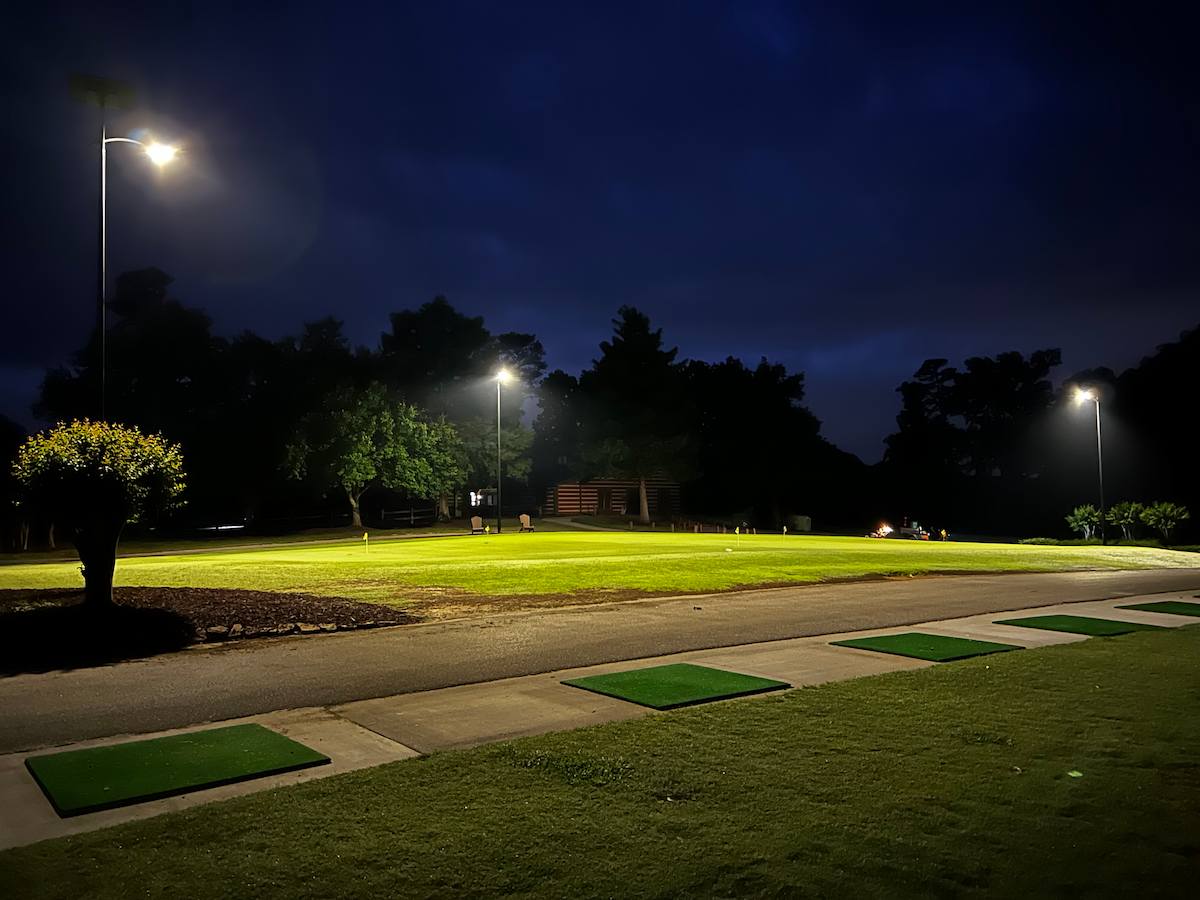 Solar street lighting illuminating a school crosswalk at night with children crossing sign visible, promoting safer school zones after dark.
