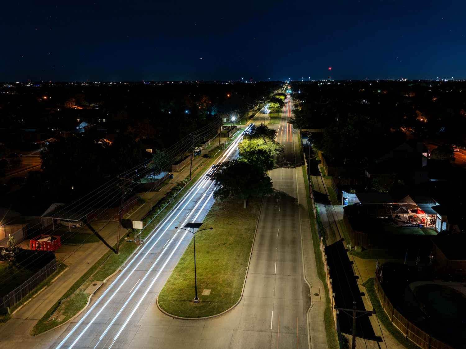 Aerial view of solar streetlights illuminating Rowlett Road at night in Rowlett, Texas