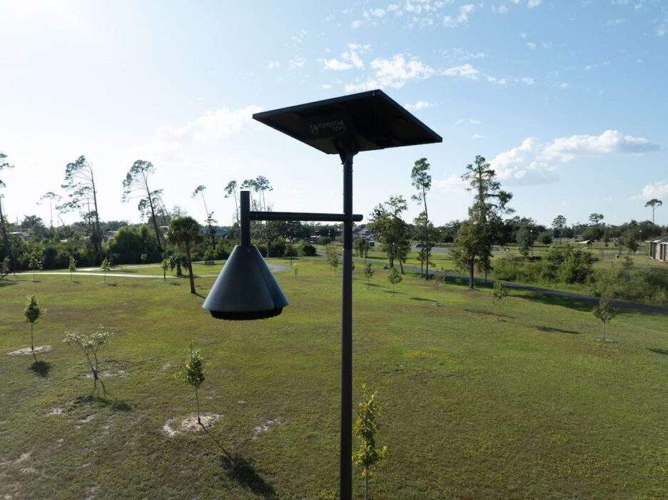 Close-up of solar streetlight installed in a green public park in South Carolina under a clear sky.