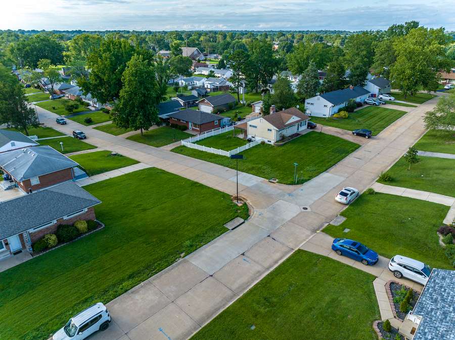 A rural neighborhood with an off-grid solar streetlight installed at a residential intersection, representing lighting improvements for Georgia’s small counties and faith communities.