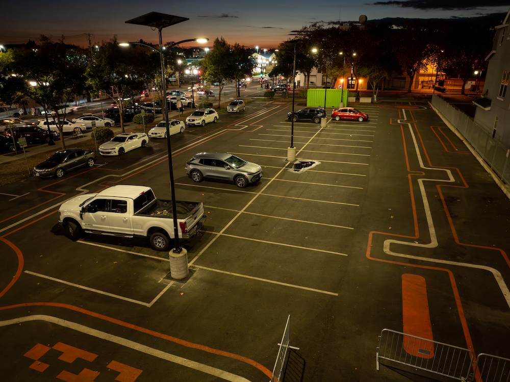 Fonroche SmartLights illuminating a public parking lot at night with off-grid solar lighting, improving safety, visibility, and energy efficiency without trenching or utility hookups.