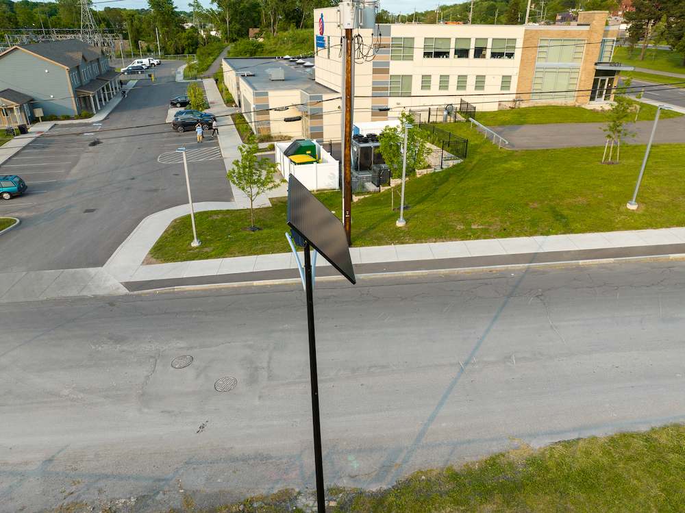 Off-grid solar streetlight installed near a municipal building and mixed-use development, ideal for scalable lighting projects in Georgia cities.