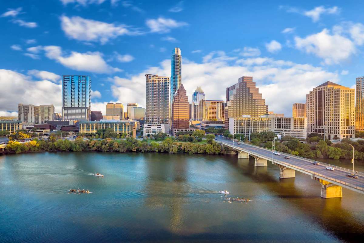 Texas Cover Skyline and riverfront view of Austin, Texas representing large-scale infrastructure growth supported by off-grid solar street lighting.
