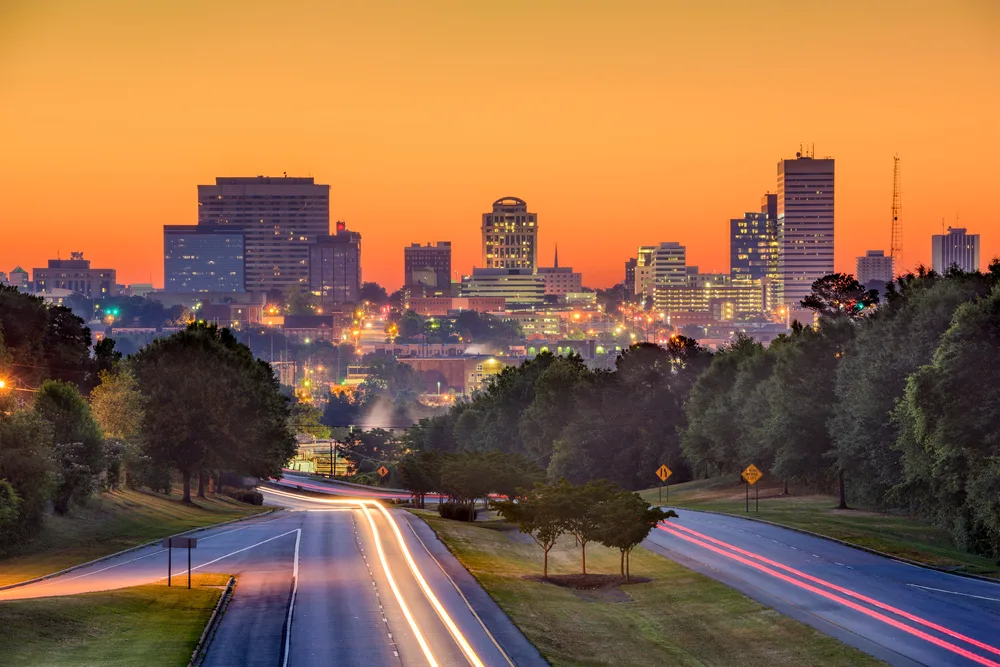 columbia-south-carolina-skyline-roadway-sunset-urban-lighting Sunset roadway view leading into Columbia, South Carolina representing reliable solar lighting for growing residential and commercial communities.