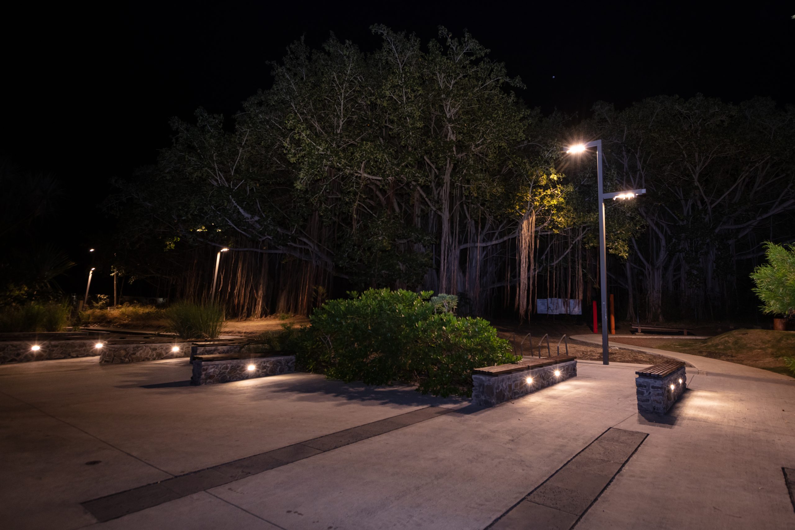 solar-crystal-studs-public-space-pathway Solar-powered pathway and landscape lighting illuminating an outdoor public space at night with smart-controlled LED fixtures and architectural lighting accents.