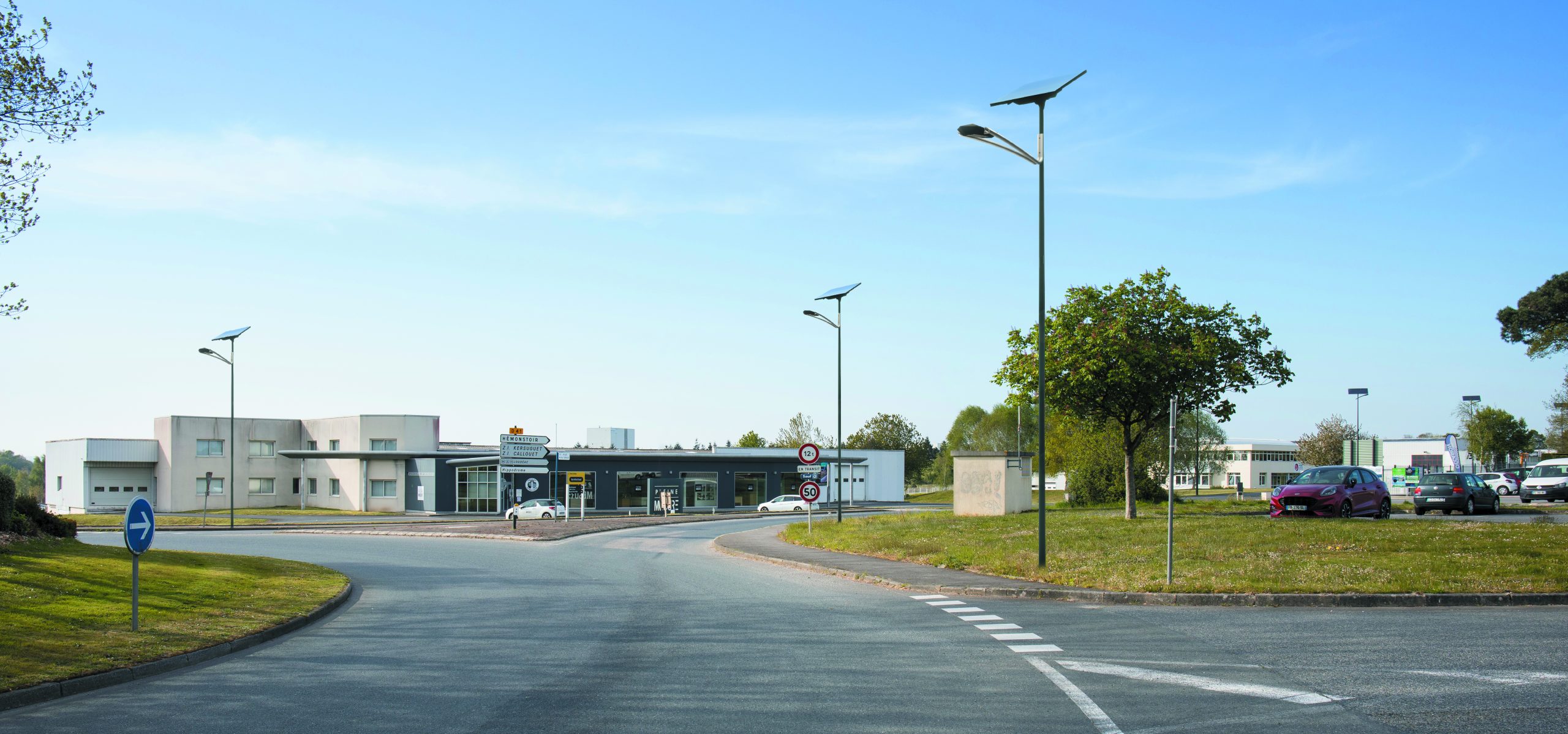 NEW ART solar streetlights installed in a commercial parking lot and roadway environment, providing modern glare-controlled illumination for public and high-traffic spaces.