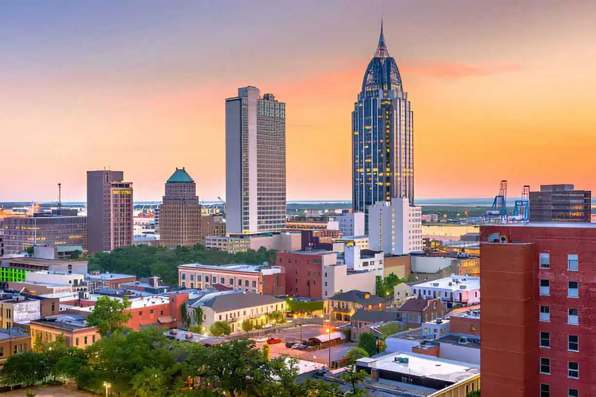 mobile-alabama-downtown-skyline-sunset-gulf-coast-city Skyline view of downtown Mobile, Alabama at sunset representing infrastructure and solar lighting projects in growing urban communities