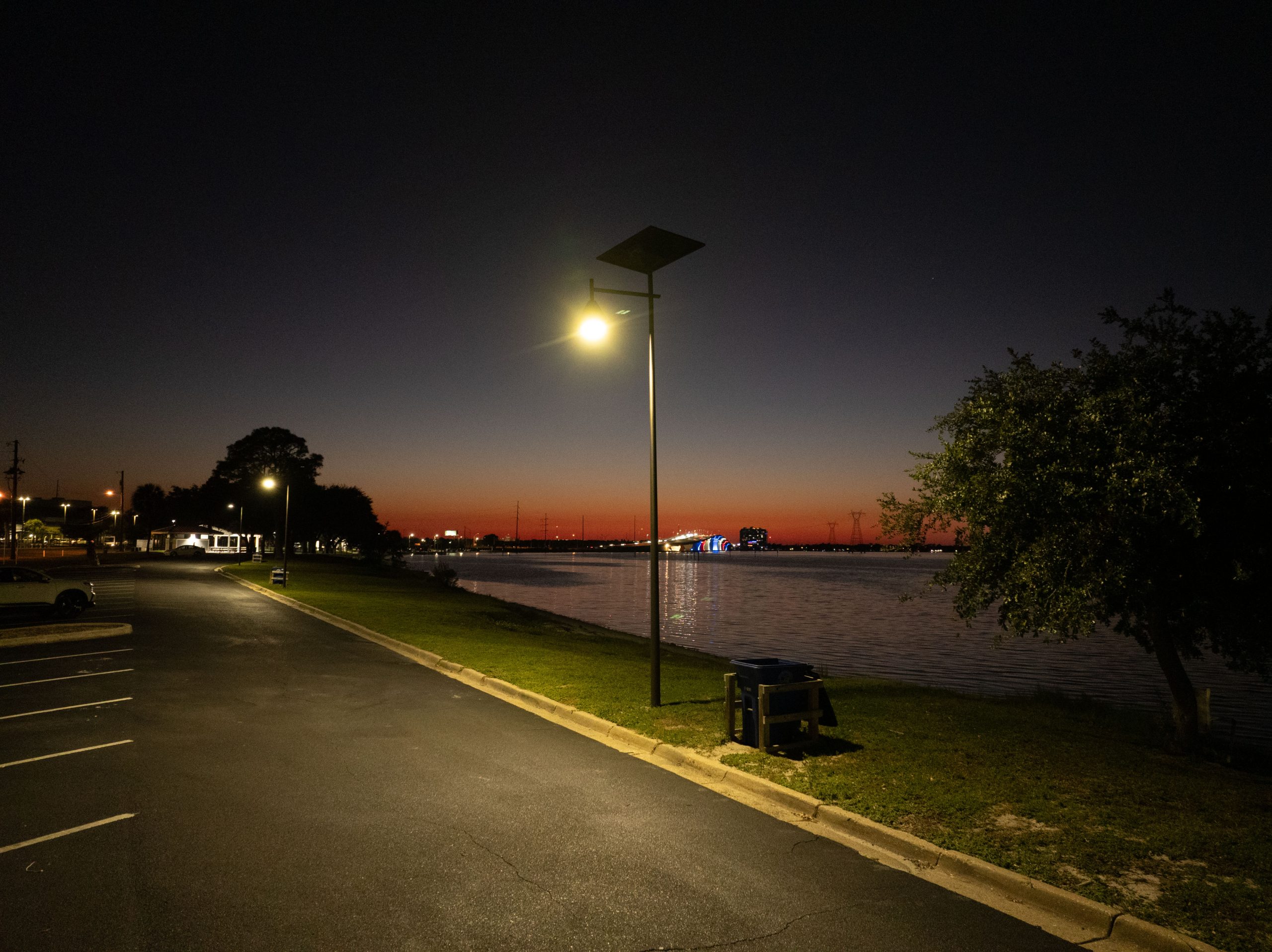 solar-street-lighting-alabama-waterfront-parking-lot-night Solar-powered street light illuminating a waterfront parking area in Alabama, providing reliable off-grid lighting for public spaces and roadways.