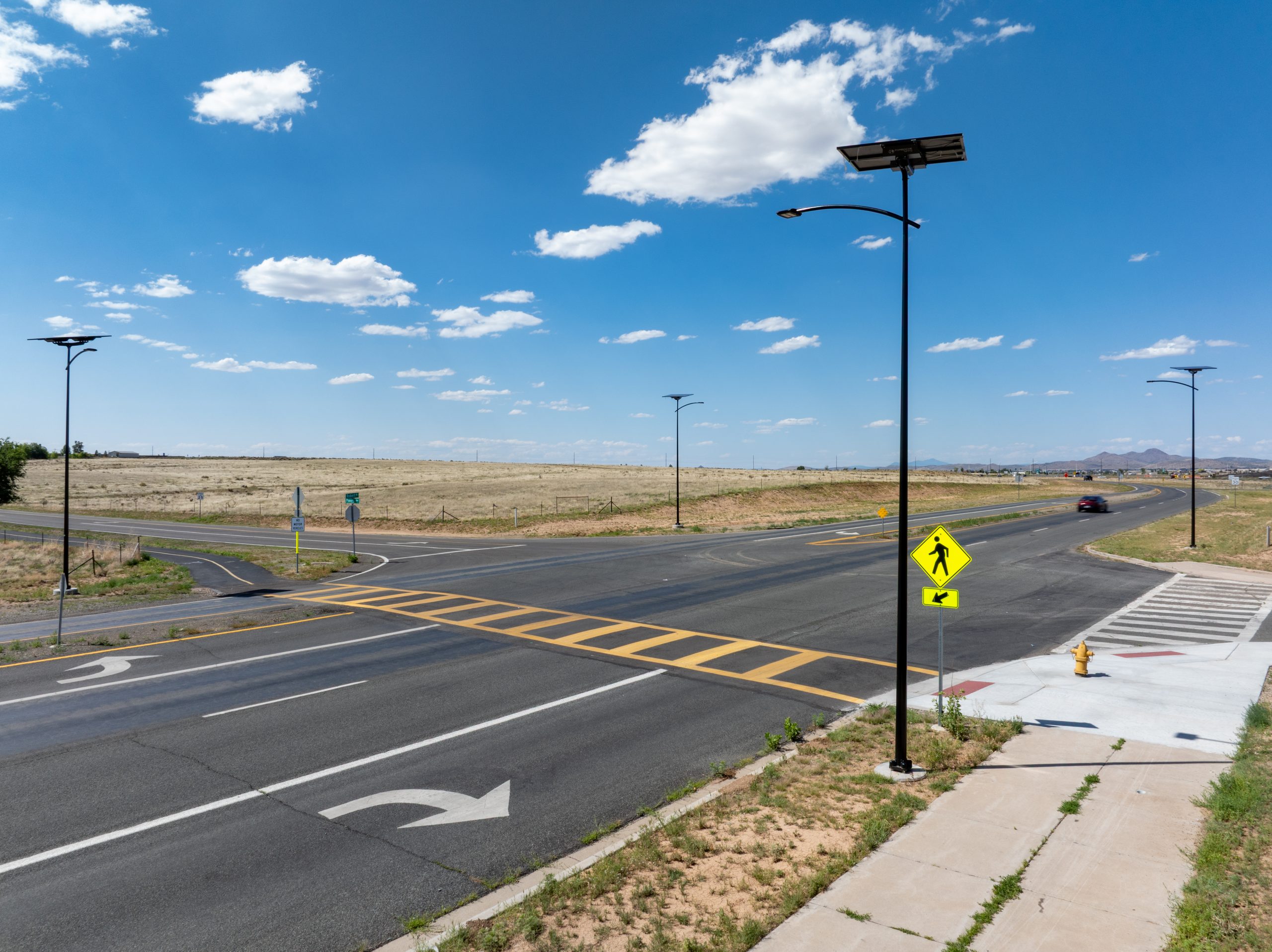 Arizona solar street lighting system providing grid-free LED illumination for a roadway intersection, pedestrian crossing, and transportation infrastructure.