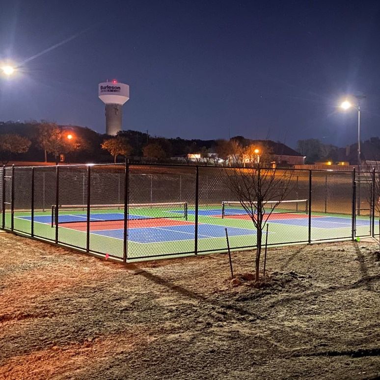 essential-solar-street-lights-pickleball-court ESSENTIAL solar street lights illuminating a community sports court for safe nighttime recreation.
