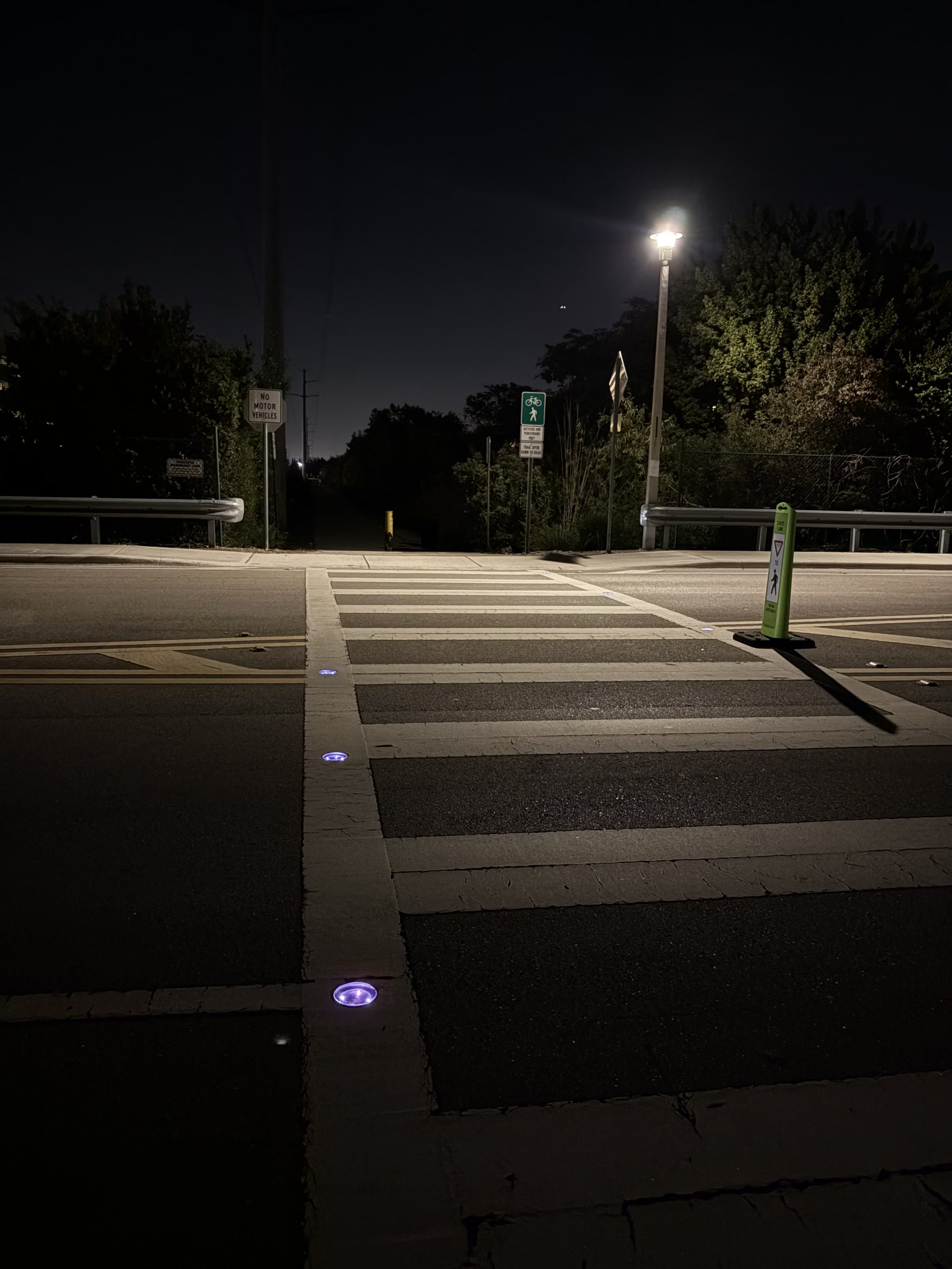 solar-pedestrian-crosswalk-lighting Solar pedestrian lighting installed at a crosswalk in an urban neighborhood