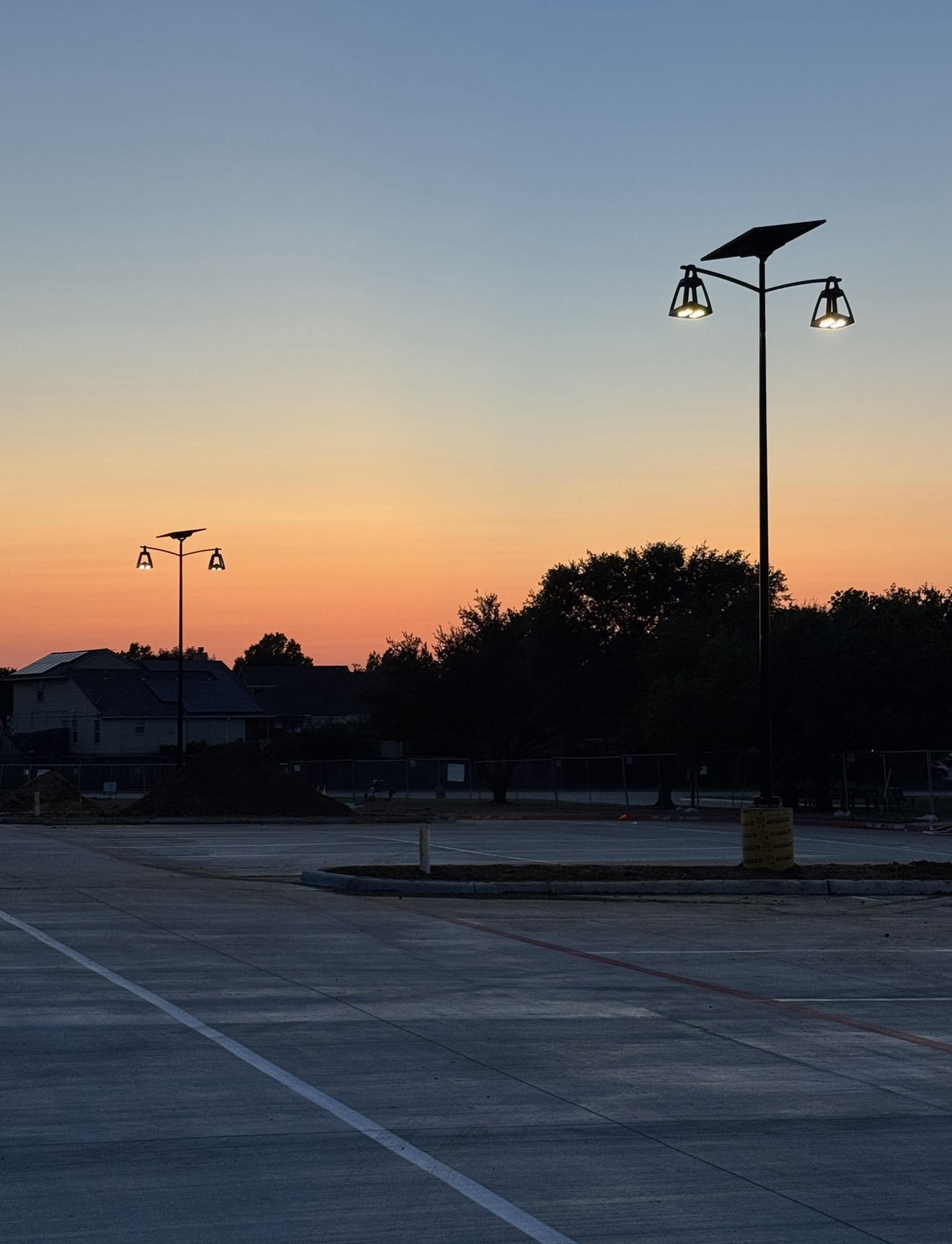 BELLE EPOQUE solar streetlight illuminating a landscaped residential roadway with elegant off-grid lighting designed for streetscapes, heritage areas, and community environments.
