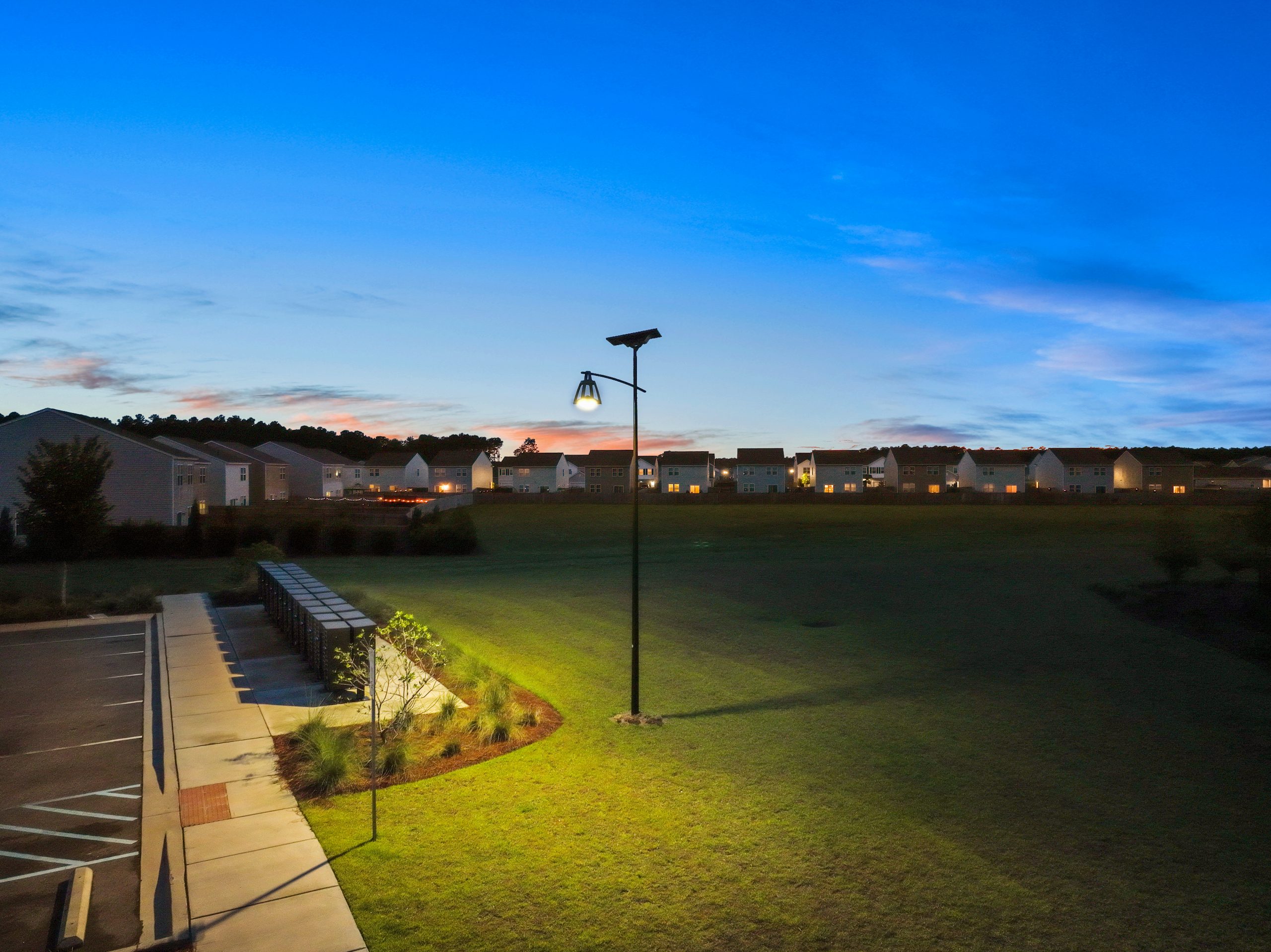 Solar-powered parking lot lights installed in a commercial parking area, providing bright, reliable off-grid illumination for expanded parking facilities and public spaces.