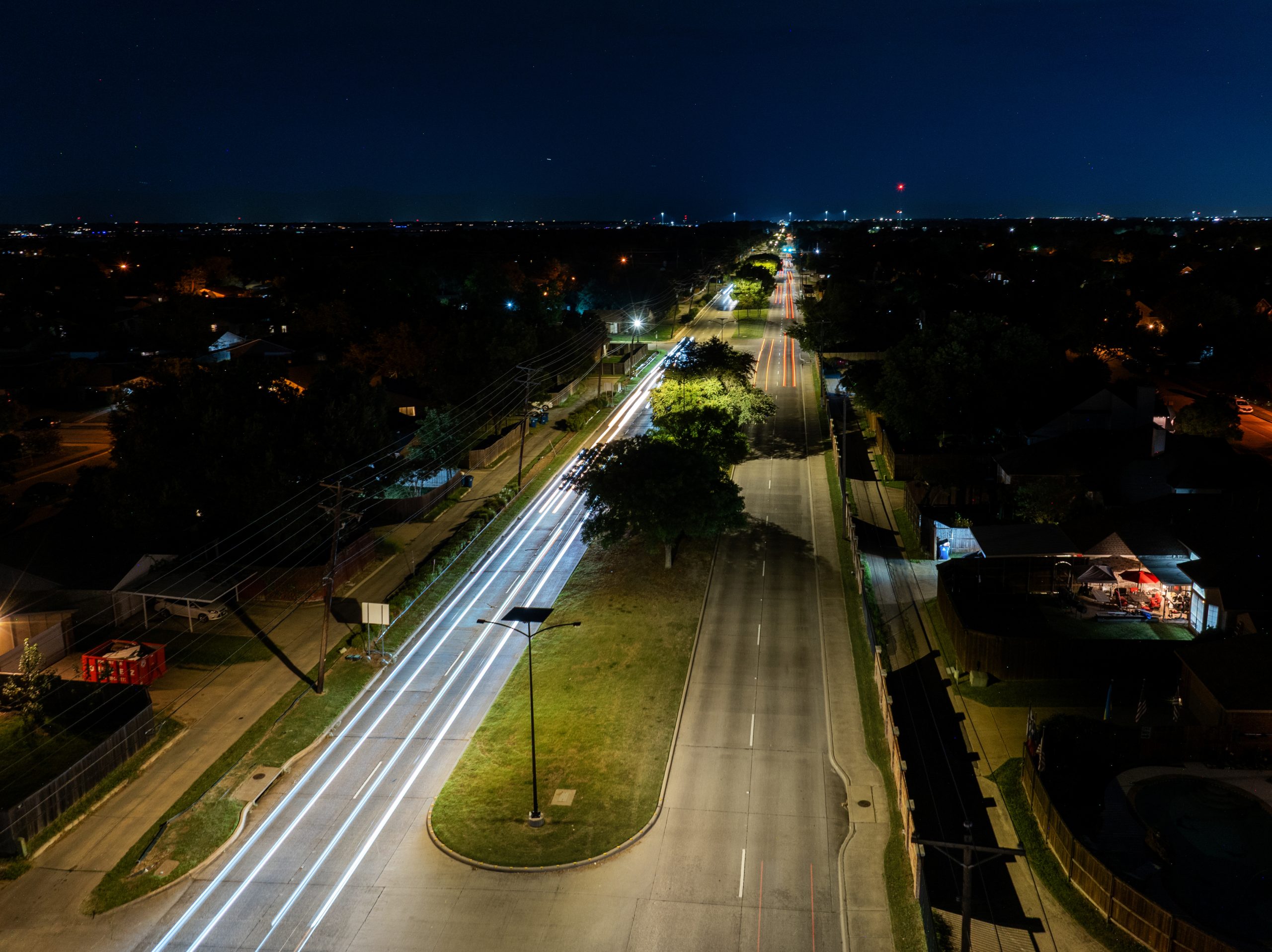essential-solar-smartlights-road-street Solar street lighting installed along a suburban roadway at dusk