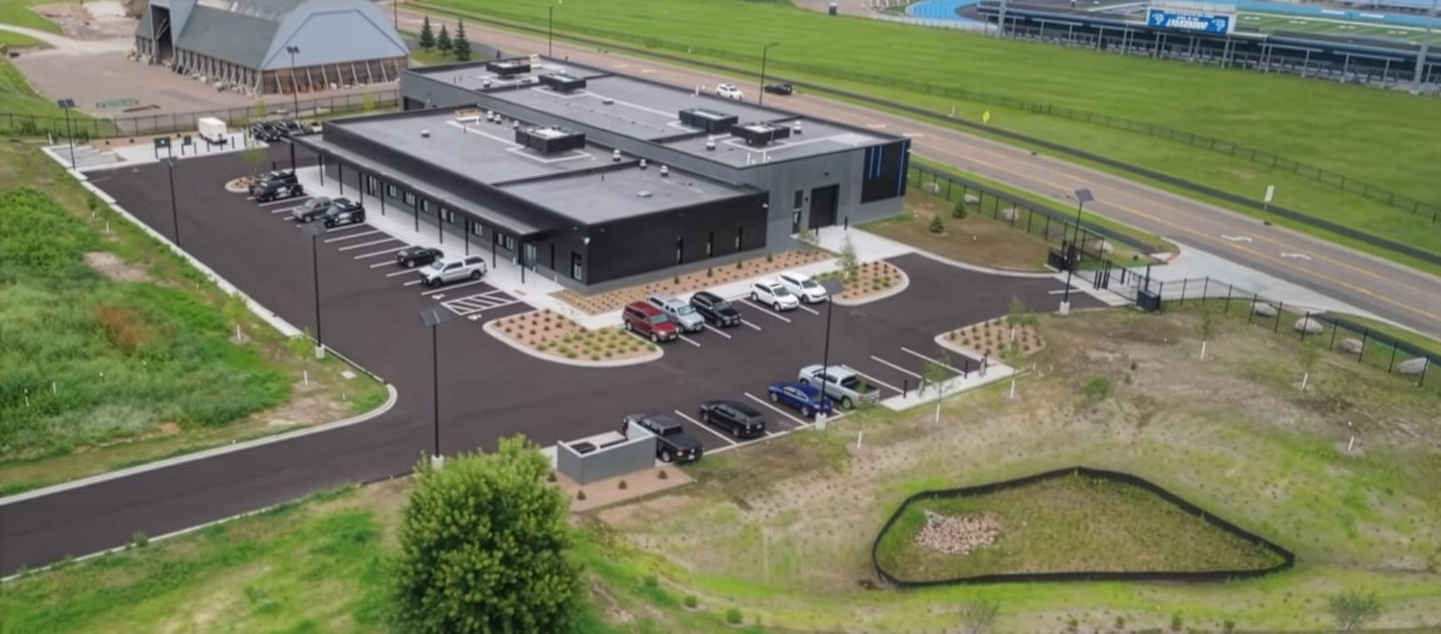 essential-solar-street-lights-military-facility Solar-powered street lighting illuminating a federal or military facility parking area at night with resilient off-grid lighting designed for secure government infrastructure.