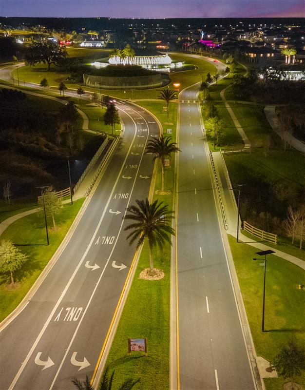 essential-solar-street-lights-road-street Solar LED streetlights illuminating a major urban intersection at night