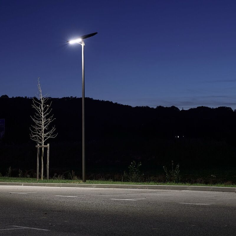helia-solar-street-light-road-street HELIA solar streetlight providing bright off-grid illumination for parking lots and outdoor areas at night with a clean modern lighting design.