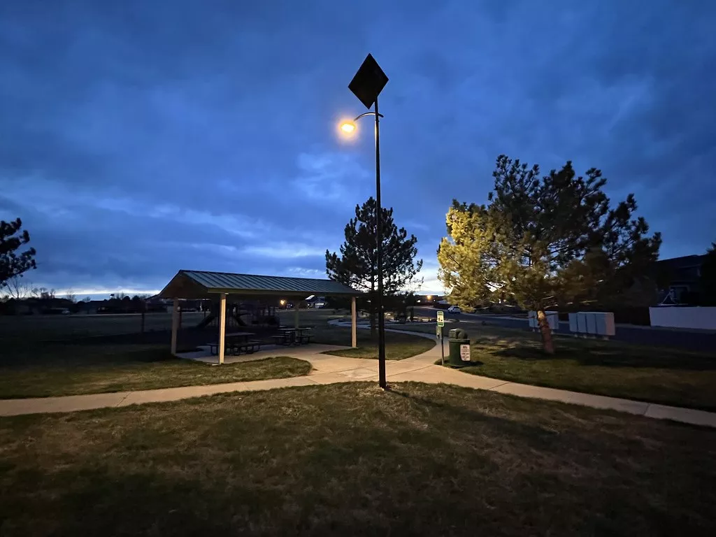 Power 365 off-grid solar street light illuminating a Virginia park pathway at dusk, providing reliable year-round public lighting.