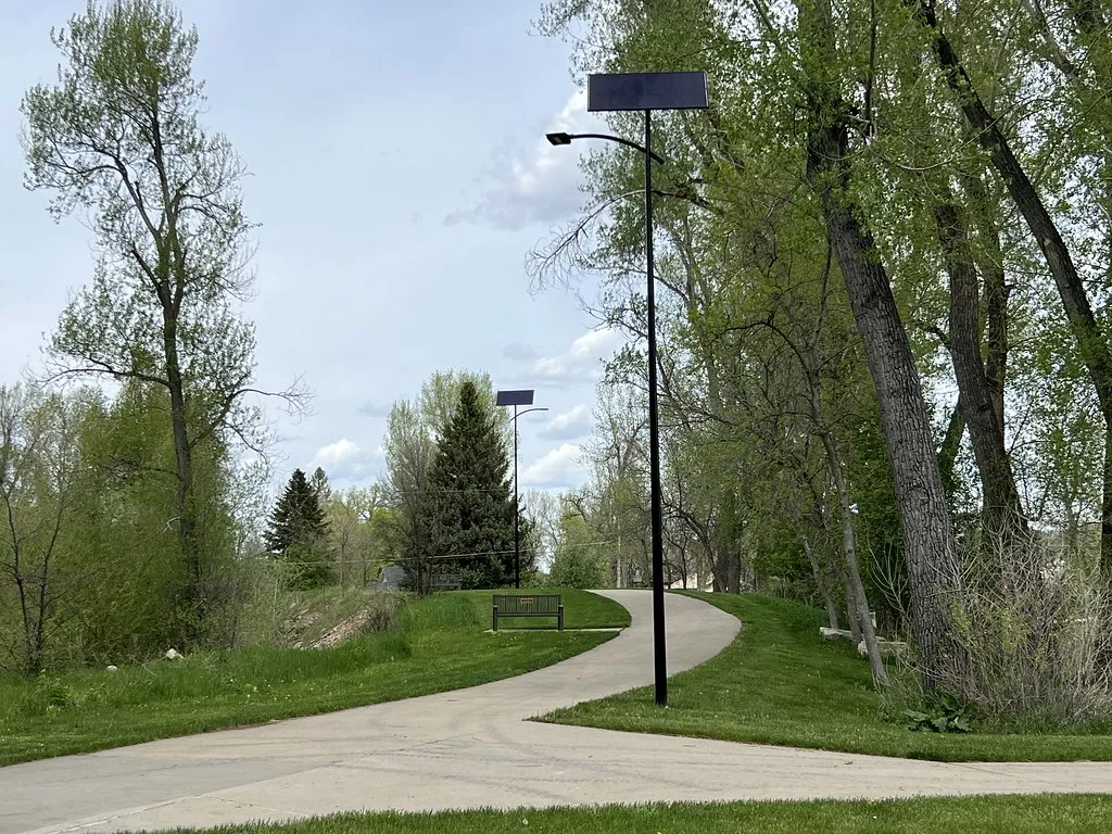 Off-grid solar pathway lights illuminating a walking trail in Virginia to improve safety and visibility in public parks.