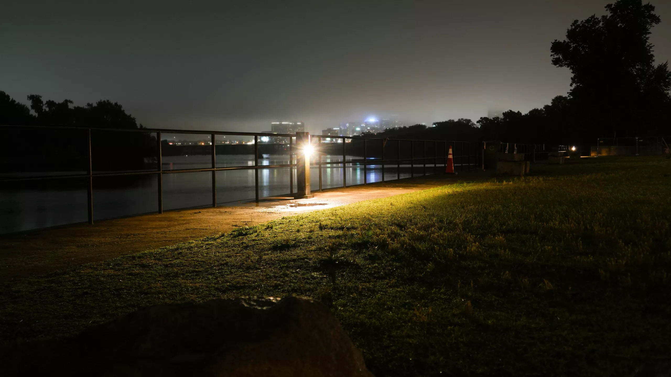 Solar landscape lighting illuminating a waterfront pedestrian pathway at night