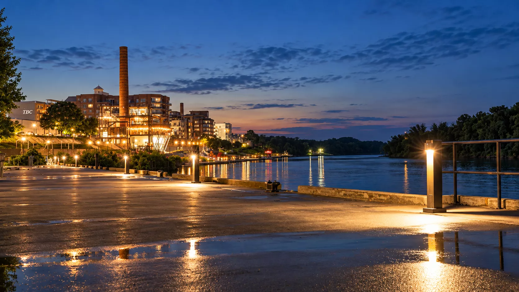 Solar bollard lighting illuminating a commercial waterfront walkway at night