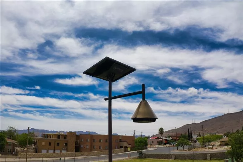 OPERA decorative solar street light with suspended lantern design in a public outdoor space