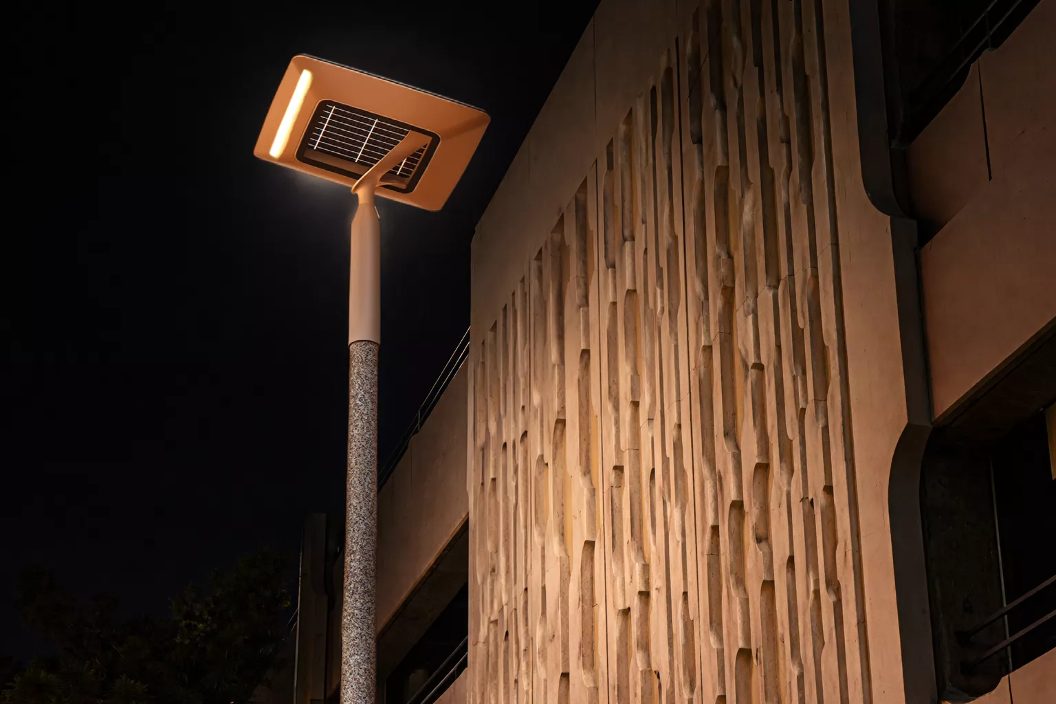 HELIA solar LED street light illuminating an outdoor area at night