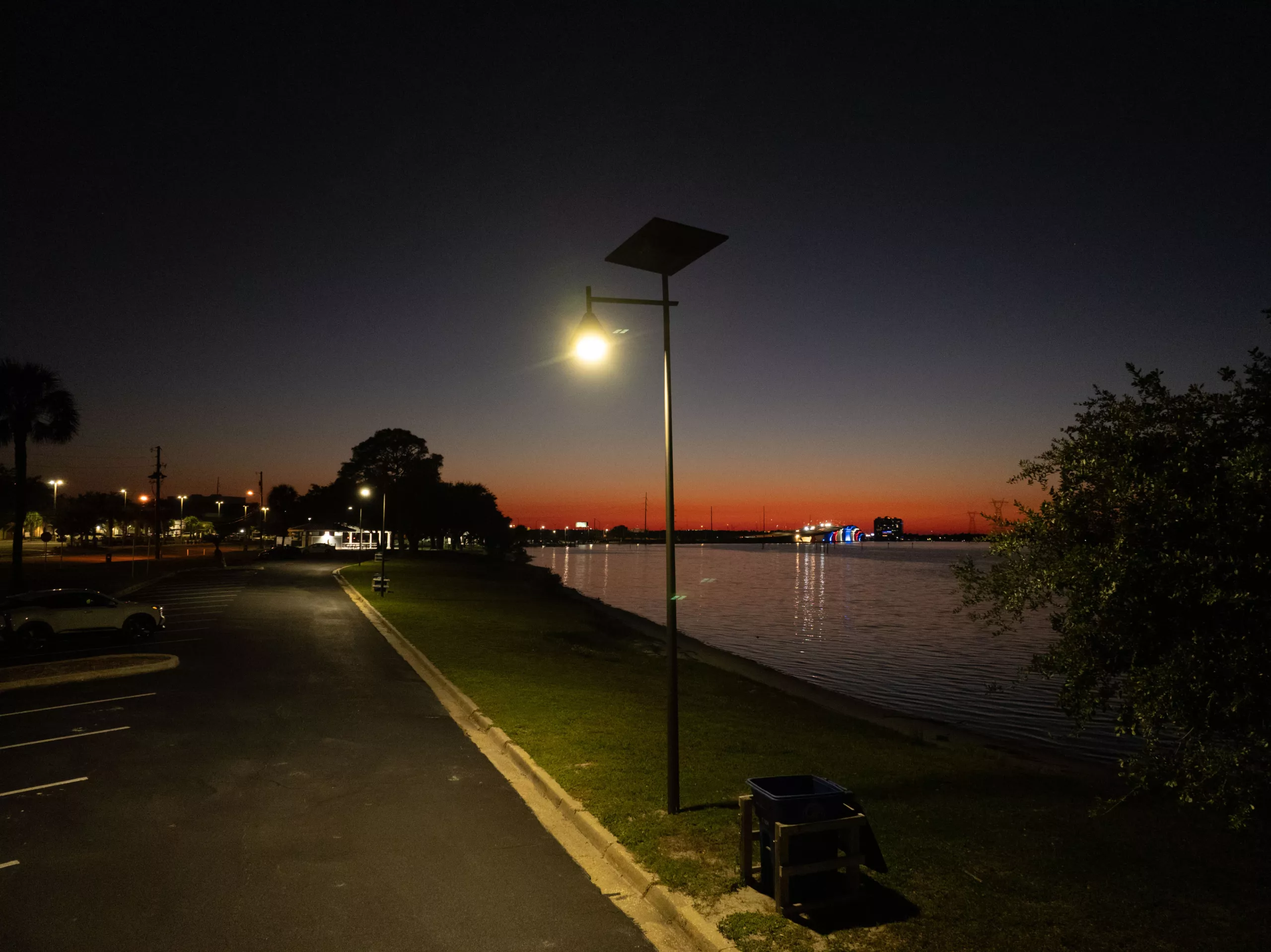 Off-grid solar street light illuminating a Florida waterfront area at night